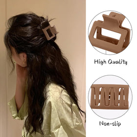 Drnytunk hair clips in a hand showing their lightweight design