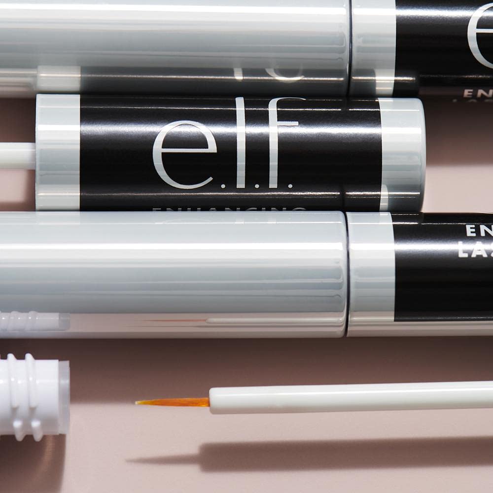 e.l.f. Lash & Brow Serum on a vanity with makeup tools
