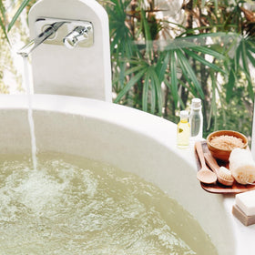 Earthborn Elements Tea Tree Epsom Salt 8 lb in a bath setting
