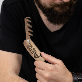 Enjoy The Wood Beard Comb on a wooden surface