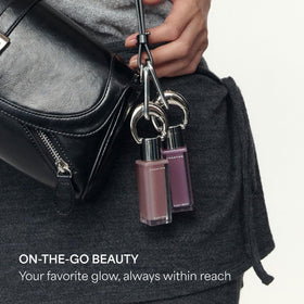 ENTROPY Glossy Lip Tint Beryl Charm on a makeup table