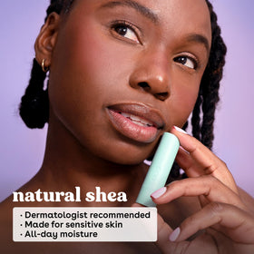 eos Coconut Milk Lip Balm tube with tropical background