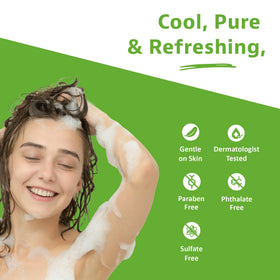 Essentials Tea Tree Mint Shampoo bottle with mint leaves