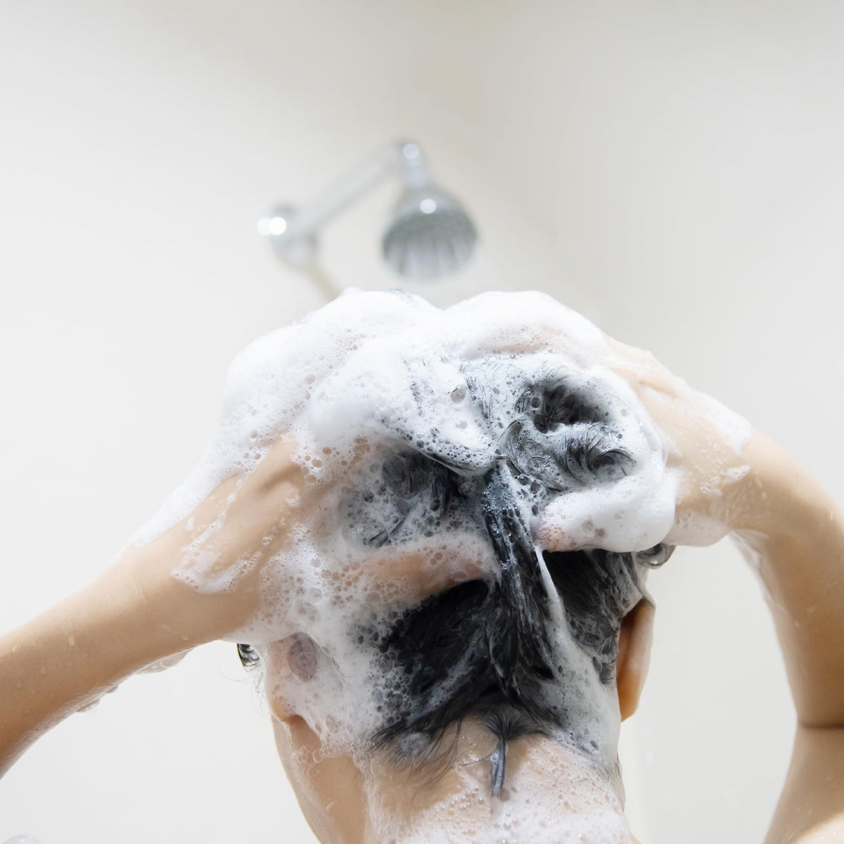 Essentials Tea Tree Mint Shampoo in a bathroom setting