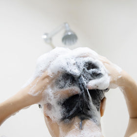 Essentials Tea Tree Mint Shampoo in a bathroom setting