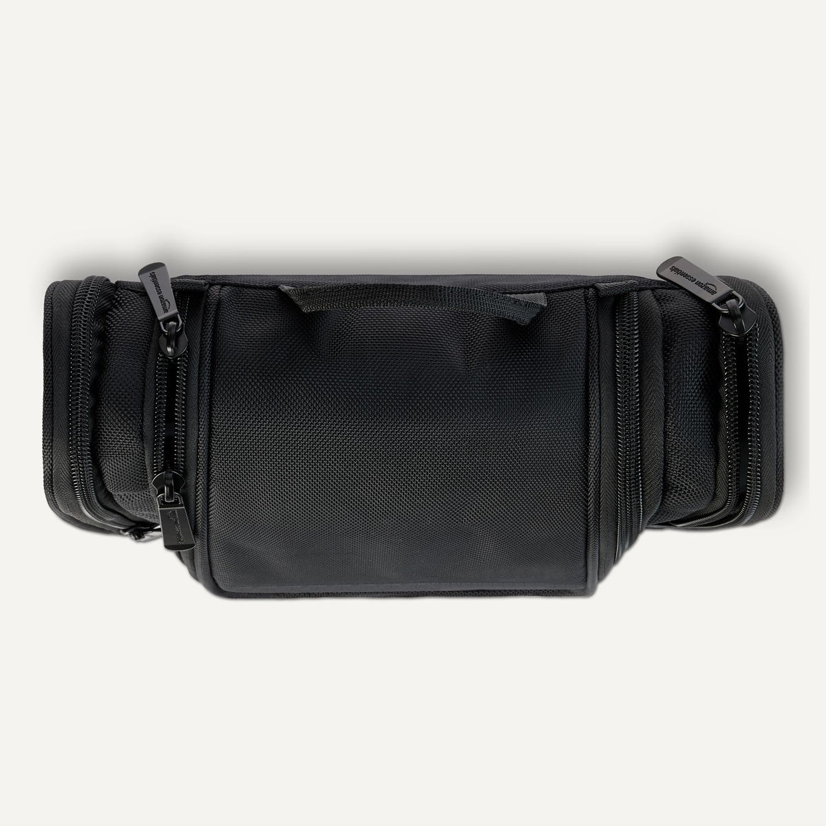 Essentials toiletry bag hanging on a towel rack