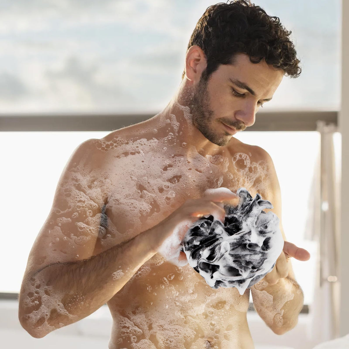 Farmoga Bath Loofah Sponge showing rich lather with soap