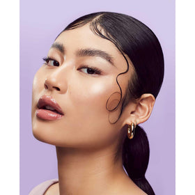FENTY BEAUTY Hair-Thickening Edge Control Gel on a styling table