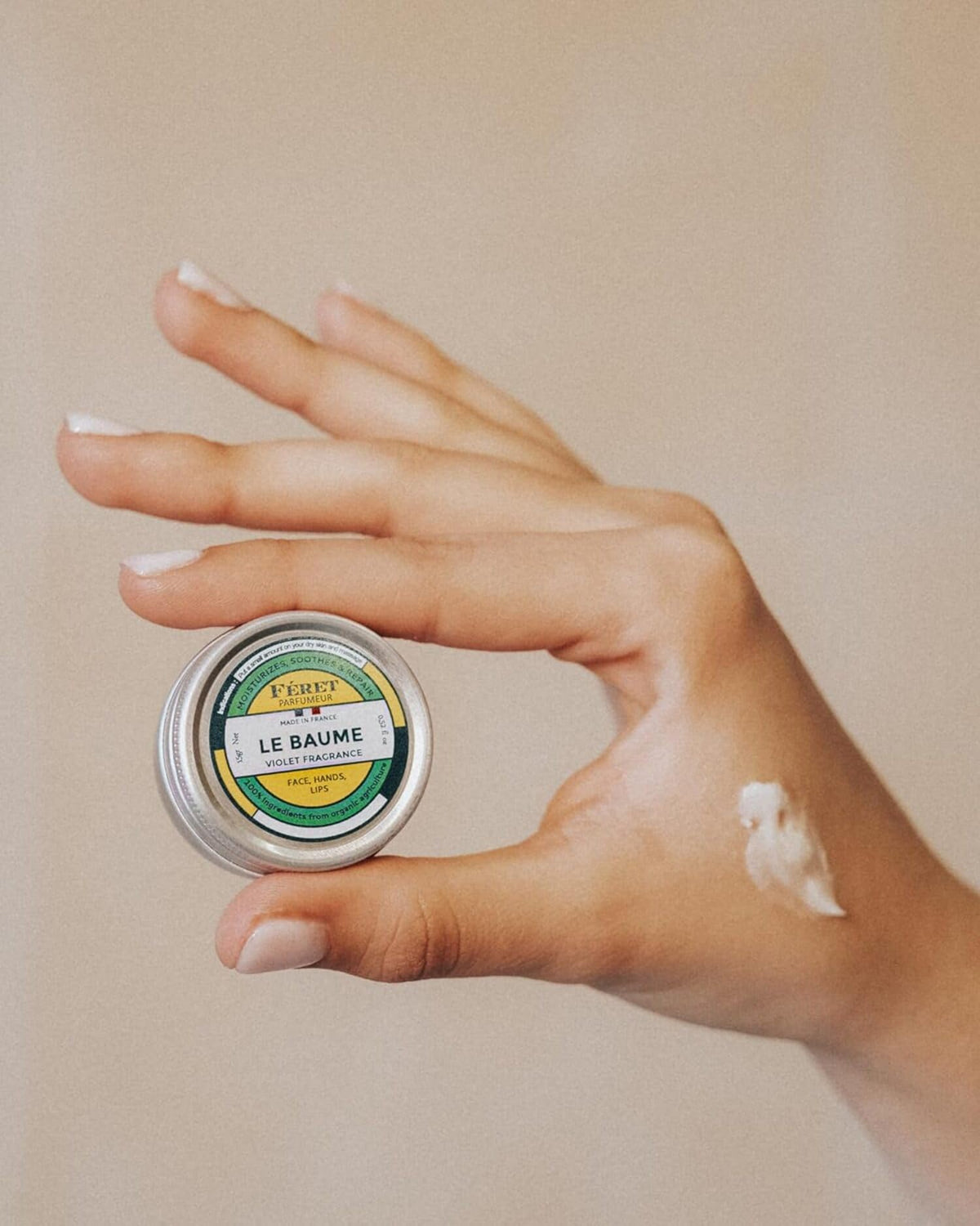 Feret Parfumeur balm applied to lips for hydration