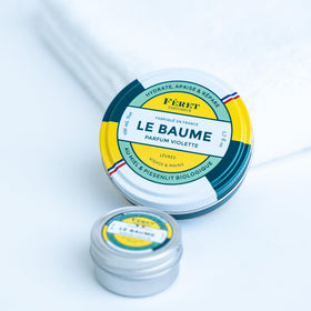 Feret Parfumeur balm with floral background highlighting its violet scent