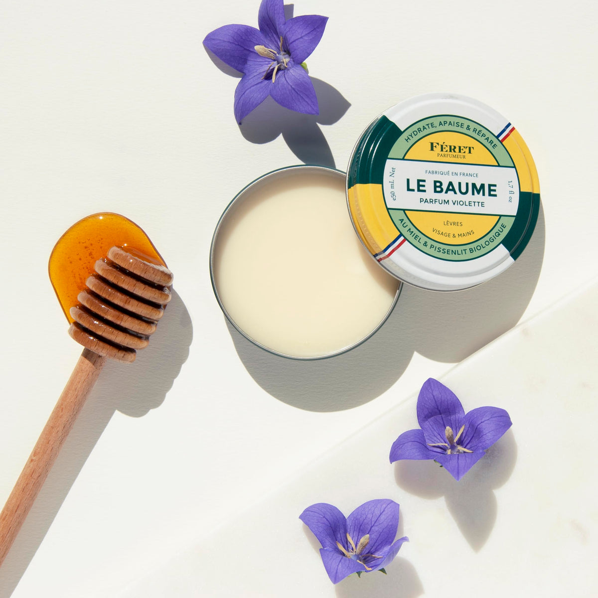 Feret Parfumeur Violette Balm displayed with natural ingredients