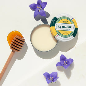 Feret Parfumeur Violette Balm displayed with natural ingredients