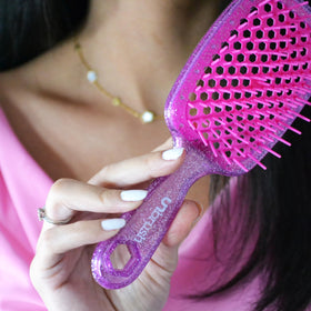 FHI Heat UNbrush Detangling Brush displayed with hair care products