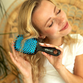 FHI Heat UNbrush Detangling Brush displayed with hair care products