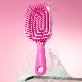 FHI Heat UNbrush Flex Detangling Brush in a stylish bathroom setting