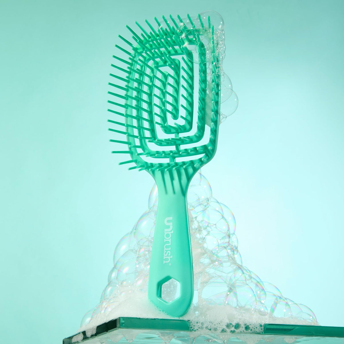 FHI Heat UNbrush Flex Detangling Brush in a stylish bathroom setting