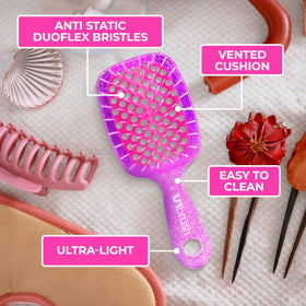 FHI Heat UNbrush Mini Detangling Brush on a bathroom counter