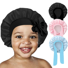 FIRSTPELLA Kids Silk Bonnet on a child's pillow