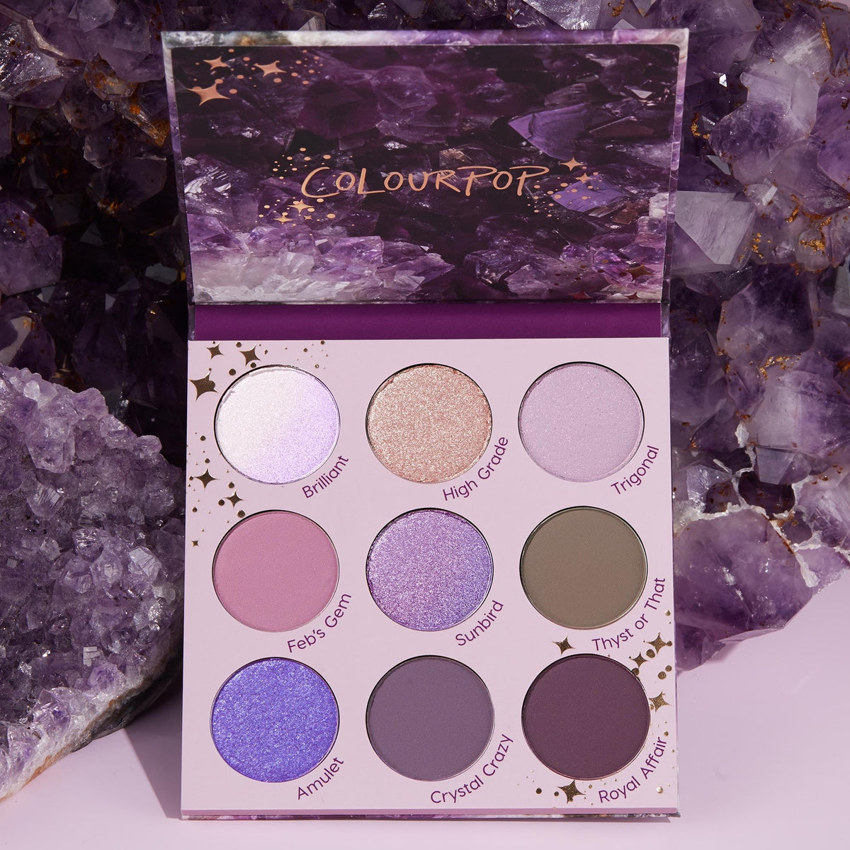 Flat lay of ColourPop All Amethyst Eyeshadow Palette with brushes