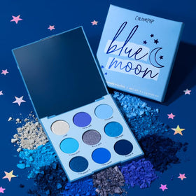 Flat lay of ColourPop Blue Moon Eyeshadow Palette with brushes