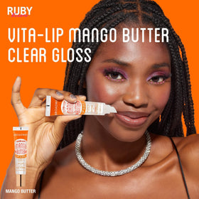 Flat lay of Ruby Kisses Vita-Lip Gloss with makeup accessories