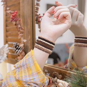 Flat lay of SYGY boho hair ties and bracelets