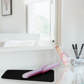 Fouews mat with hot hair tools placed on it
