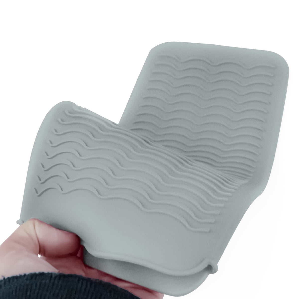 Fouews Silicone Heat Resistant Mat being rinsed in warm water