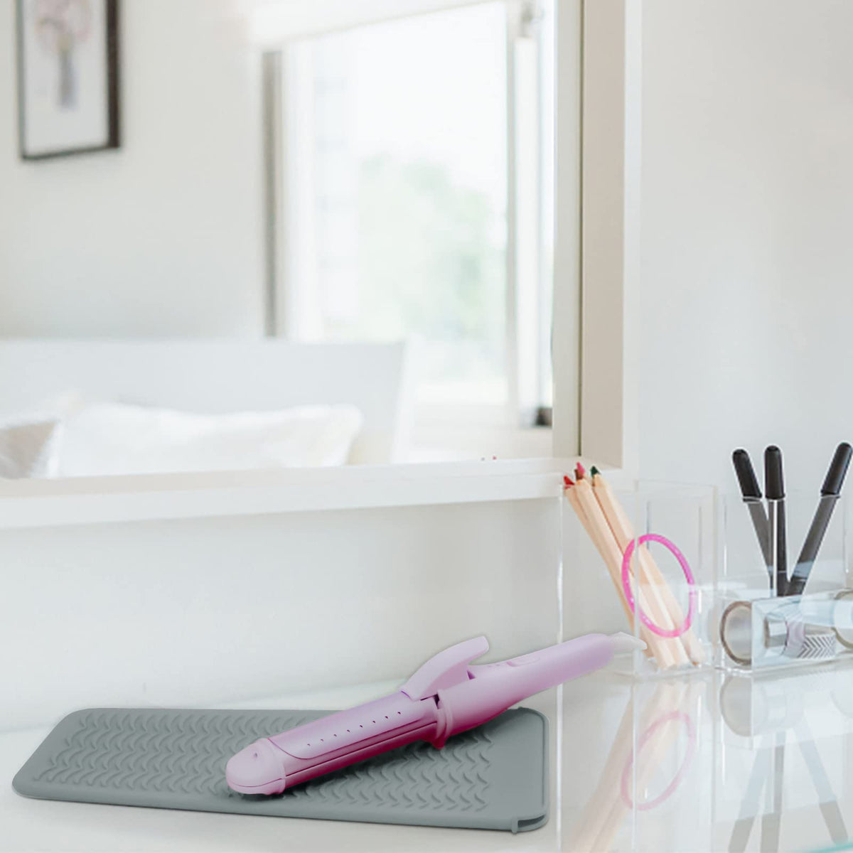 Fouews Silicone Heat Resistant Mat on a countertop with hair tools
