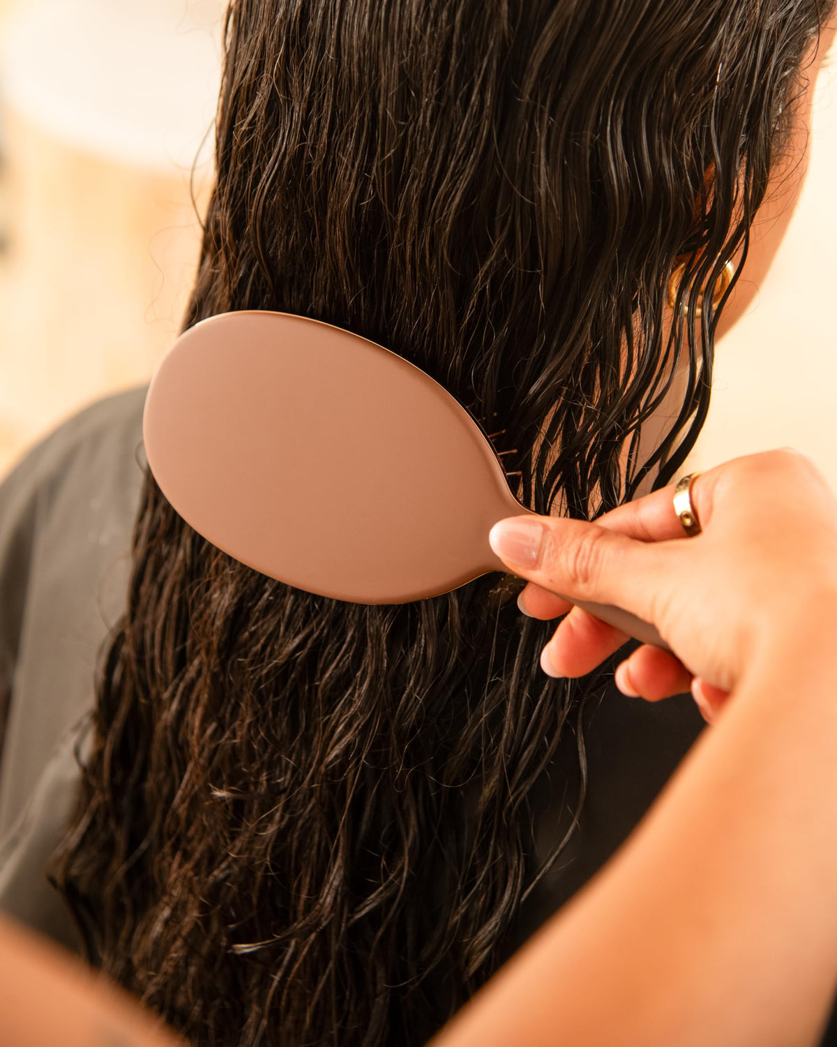 FRAMAR Chocolate Hair Brush Detangler in a hand