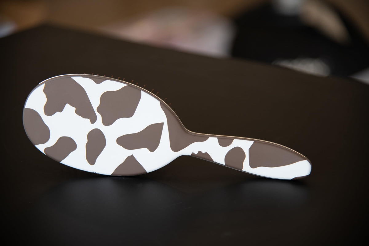 FRAMAR Cow Print Hair Brush Detangler in a purse