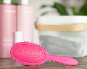 FRAMAR Detangling Brush being used on curly hair