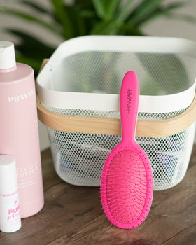 FRAMAR Detangling Brush displayed with other hair care tools