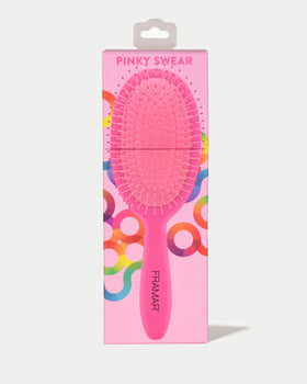 FRAMAR Detangling Brush in green on a vanity
