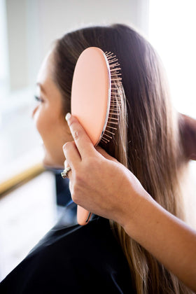 FRAMAR Detangling Brush in use on curly hair
