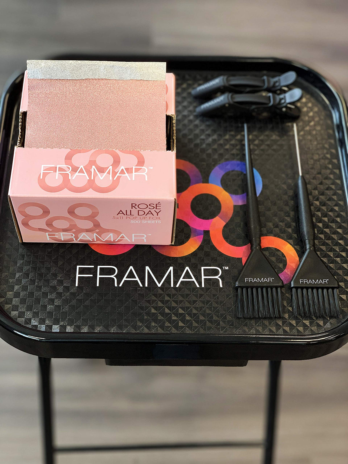 FRAMAR Rosé Hair Foils in a stylist's hand