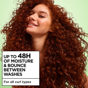 Garnier Curl Refresher on a bathroom counter with curly hair products