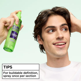 Garnier Fructis Curl Shape Defining Spray Gel being applied to hair