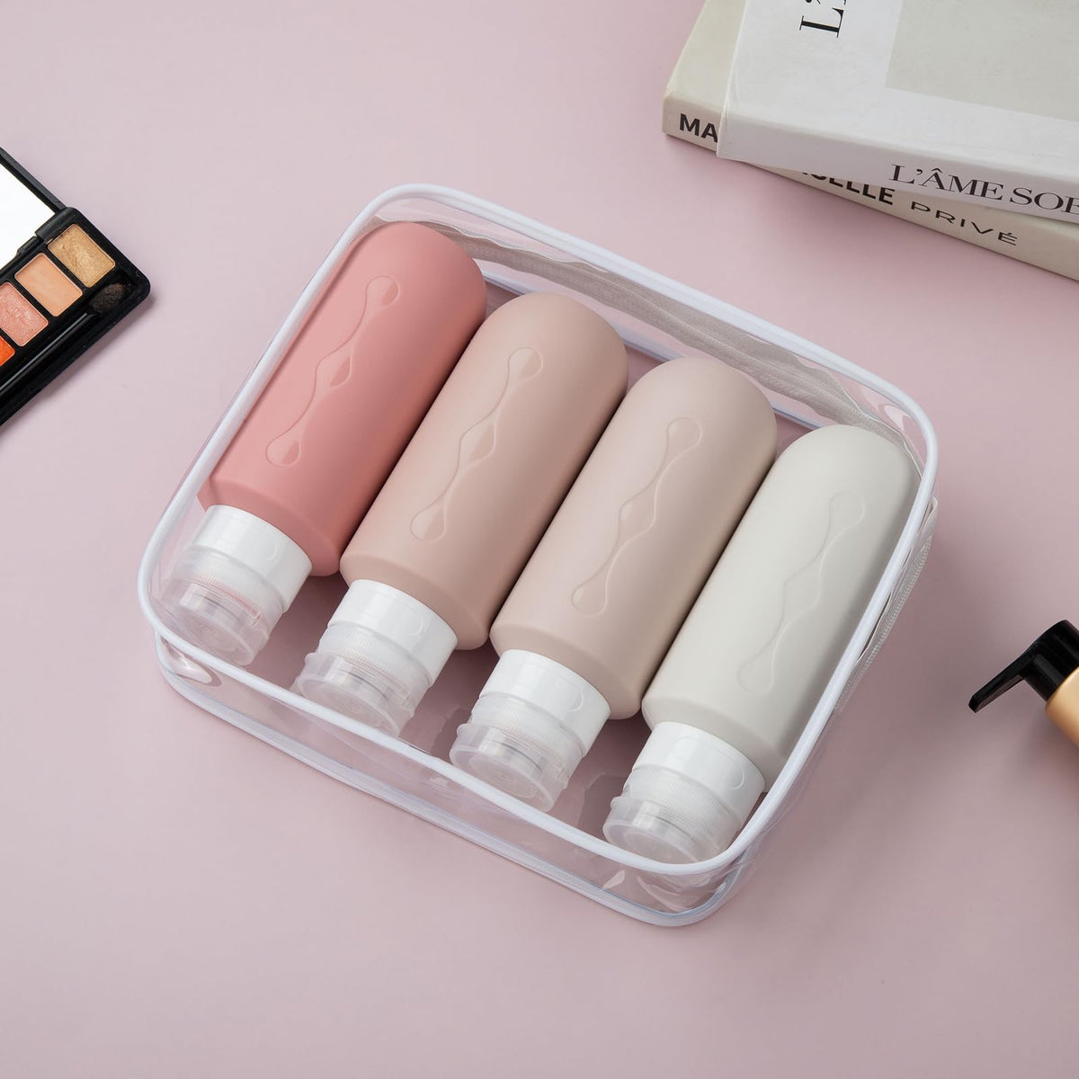Gemice travel bottles arranged in a clear toiletry bag