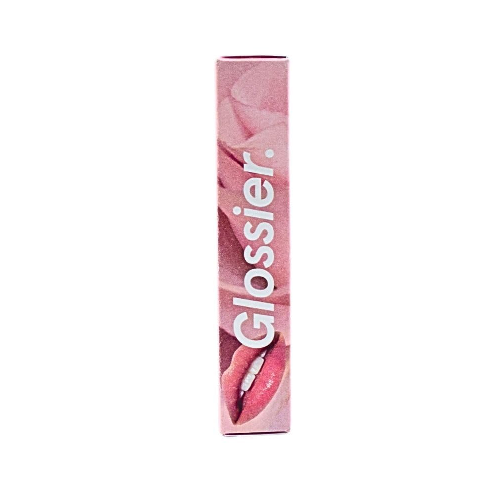 Glossier Balm Dotcom against a natural background