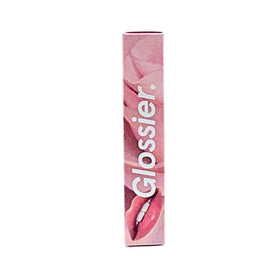 Glossier Balm Dotcom against a natural background