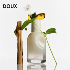 Glossier fragrance bottles displayed on a travel-friendly background