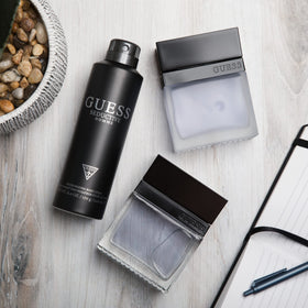 GUESS Seductive Homme Eau de Toilette bottle on a wooden table