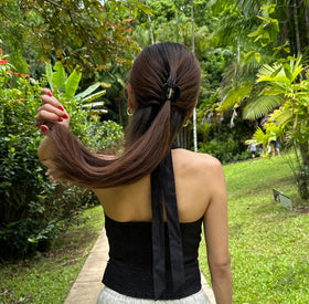 Hana Mia black claw clip held in a woman's hair styled in a half-up