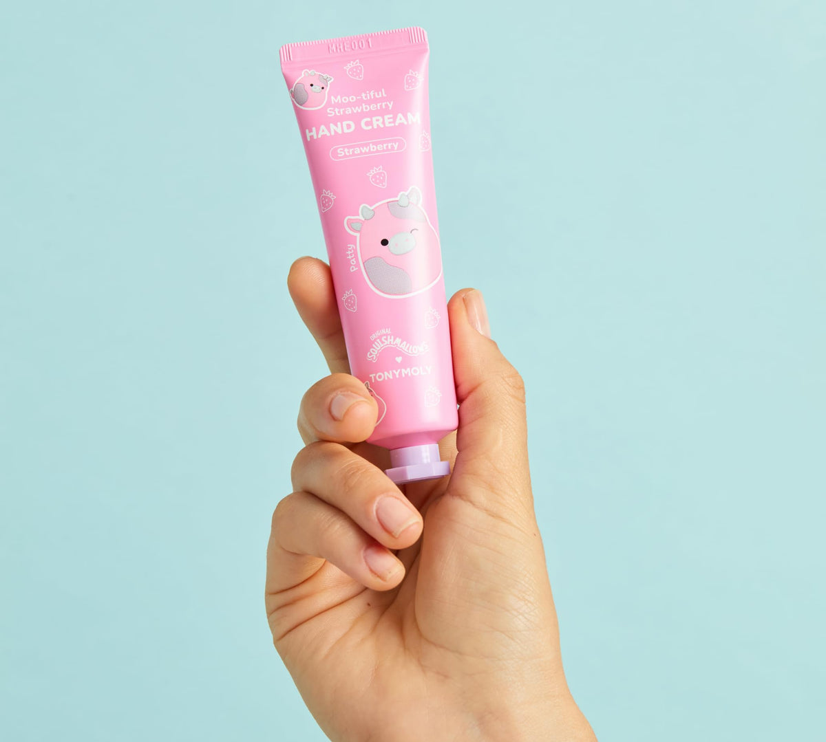 Hand Cream and Lip Gloss set on a pastel background