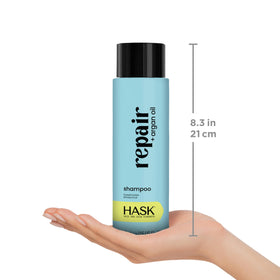 HASK Repair Argan Oil Shampoo and Conditioner set on a bathroom shelf