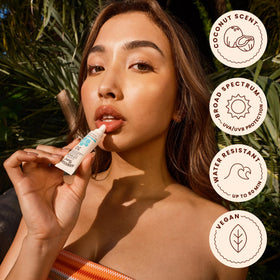 Hawaiian Tropic Lip Balm Island Coconut SPF 30 with beach background