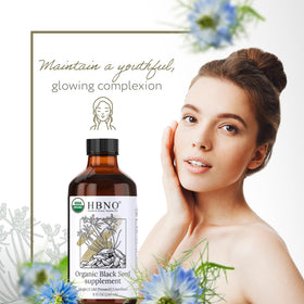 HBNO Organic Black Seed Oil 8oz pouring into a hand