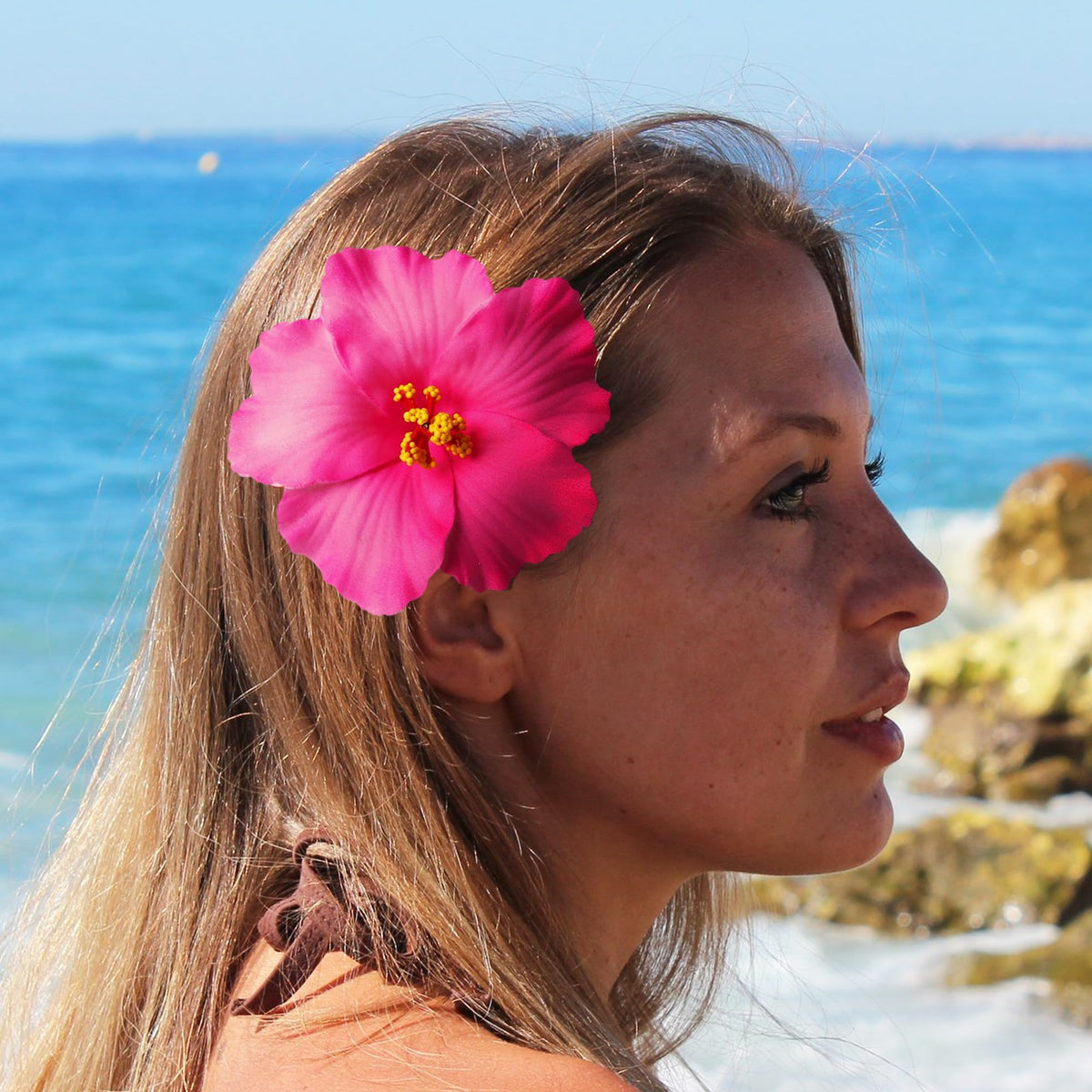 Heyiminy Hawaiian Flower Hair Clips on a table with tropical decor