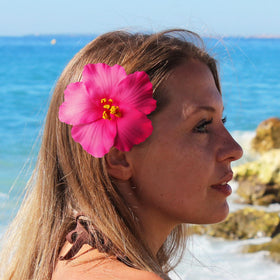 Heyiminy Hawaiian Flower Hair Clips on a table with tropical decor